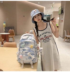 Tie-dye backpack detail with star and bone appliques and blue plaid bucket hat styling