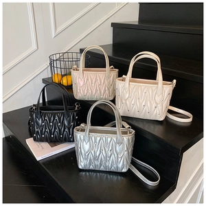 Detailed view of four quilted crossbody bags with rhinestones in diverse colors