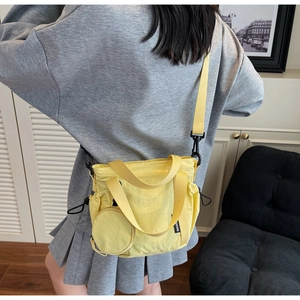 Yellow nylon bucket bag with side drawstring detail and matching round coin purse pouch