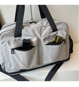 Detail of travel bag showing front zipper pockets and large storage capacity features