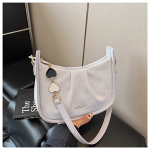 Détail d'un sac seau plissé violet clair avec un pendentif en forme de cœur très tendance