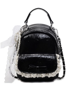 Mini sac à dos en cuir noir avec bordure en dentelle, nœuds et chaîne perlée