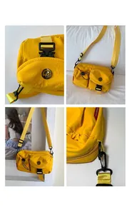 Detail view of yellow nylon crossbody bag with multiple pockets and black buckles