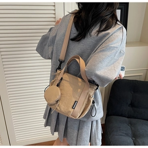 Detail of khaki nylon bucket bag with detachable strap and small round coin purse