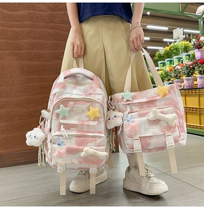 Pink tie-dye backpack set with plush charms and multiple storage pockets for students