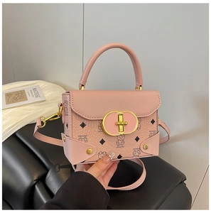 Detalle de bolso cuadrado rosa con cierre de giro dorado y diseño de patrón de osito