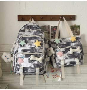 Tie-dye canvas backpack set featuring plush star patches and matching tote bag on wooden hanger