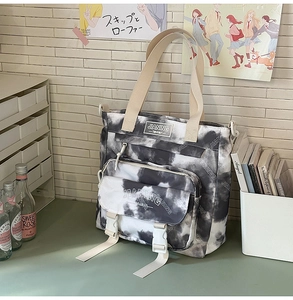 Detail of tie-dye canvas backpack with functional front pockets and sturdy buckles