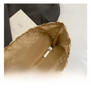 Detail view of the straw bag interior featuring secure zipper closure and fabric lining
