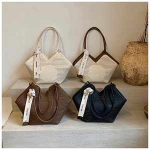 Detail of laser-cut logo on premium leather tote bags with silk scarf handle wrap