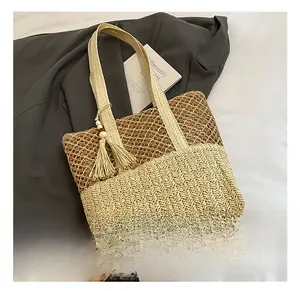 Detailed view of beige and brown woven straw tote bag texture with stylish tassel