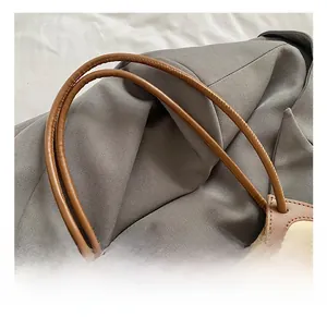 Detail of comfortable faux leather handles and canvas texture on hollow tote bag