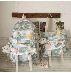 Green tie-dye backpack set detail with plush charms and branded woven label