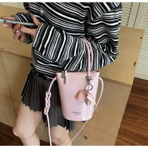 Detail of pink bucket bag with leather elephant charm and fashion leather branding