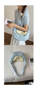Detailed view of light blue canvas tote bag featuring a cute pear shaped flap and embroidery