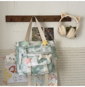 Close-up of tie-dye canvas backpack with plush star charms and JIANING brand label
