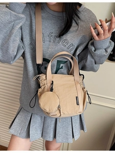 Khaki canvas bucket bag with wide strap and matching round coin purse for women