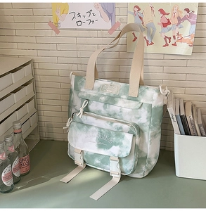 Detail of green tie-dye canvas backpack with flap pocket and double buckle closure