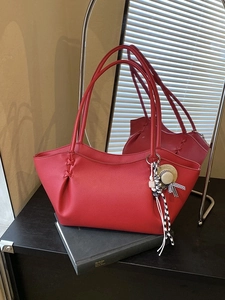 Red lychee pattern tote bag with woven sides and decorative straw hat charm