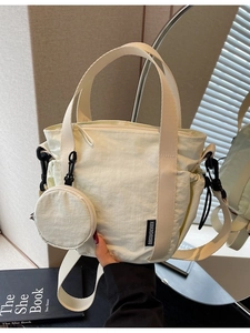 Creamy nylon crossbody bucket bag with mini coin purse and adjustable shoulder strap