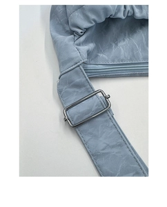 Close-up of blue marble textured nylon fabric and silver adjustable metal buckle on strap