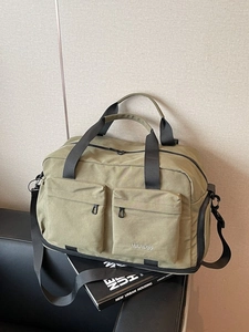 Olive green large capacity travel bag with multiple pockets and shoulder strap