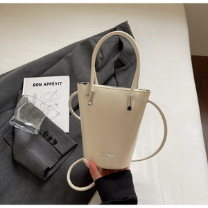 Detail of off-white bucket bag featuring the fashion leather text and fine texture