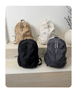 Detail of minimalist nylon backpacks in four colors with industrial rope zipper pulls