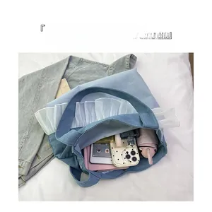 Macro shot of large capacity denim tote with white organza lace and daily essentials