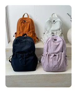 Outdoor nylon backpacks shown in multiple colors with front drawstring pocket design