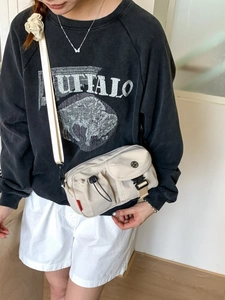 Beige multi-pocket crossbody bag in nylon fabric with tactical buckle and drawstring pouch