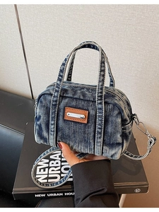 Classic blue washed denim Boston bag with leather patch detail and crossbody strap