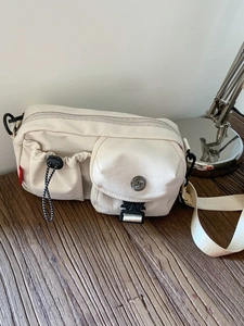 Minimalist off-white canvas crossbody bag with multi-pockets for casual daily wear