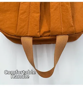 Close-up of durable nylon backpack top handle with reinforced stitching and textured fabric