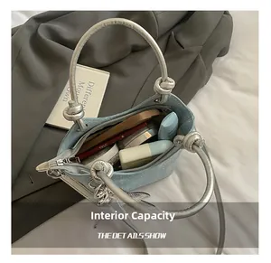 Macro shot of internal capacity showing cosmetics inside silver glitter bucket bag
