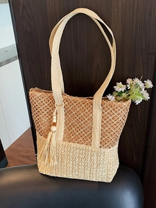 Chic hollow-out straw woven tote bag in beige with tassel detail and long shoulder straps