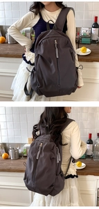 Detailed view of the large capacity nylon backpack with thick woven zipper pulls and side cords
