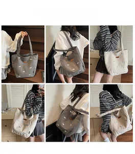 Collage of grey and beige canvas tote bags with delicate sheep embroidery on shoulders