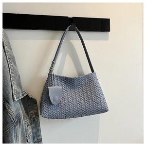 Detail of light blue woven shoulder bag with matching round coin purse on a minimalist hanger