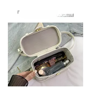 Close-up of white oval handbag interior showing large capacity for phone and cosmetics