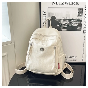 Vue détaillée du sac à dos en nylon blanc cassé avec double zip et logo géométrique