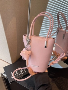Pink retro bucket shoulder bag with elephant pendant and fashion lettering detail