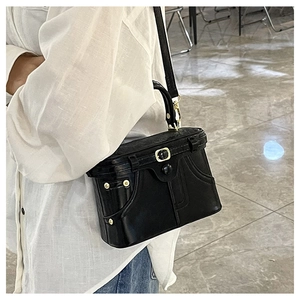 Detailed shot of creative black leather handbag featuring clothing collar and pocket design