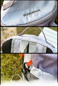 Detail of light purple nylon backpack featuring brand embroidery and orange accessory cord