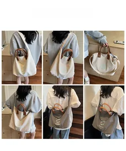Vues détaillées d'un grand sac fourre-tout en toile avec anses et bandoulière en cuir brun