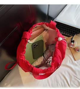 Interior view of large capacity red tote bag with inner pocket and everyday essentials