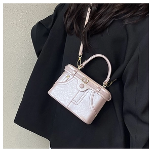 Pink pearl gloss leather handbag with trench coat strap detail and elegant metal buckle
