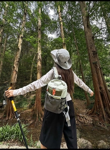 Outdoor hiking setup featuring a color-block drawstring backpack and wide-brim sun hat