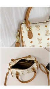 Detail view of mini Boston bag interior with zipper pocket and printed bear pattern leather