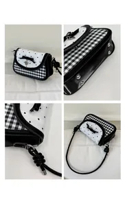 Detail view of heart pattern bag with metal studs and polished crossbody strap joints